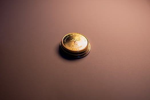 Macro shot of Ugandan Shilling coins with dramatic lighting and shadow play on a studio background.