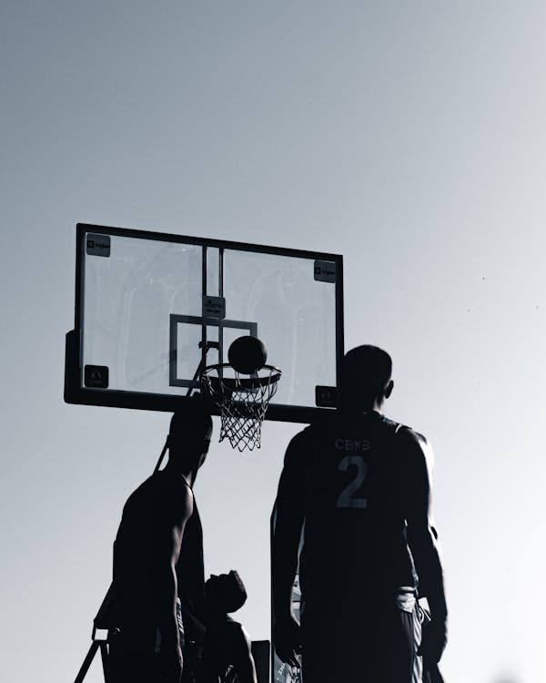 Silhouette of Men Playing · Free Stock Photo