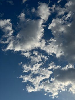 Majestic white clouds against a deep blue sky, perfect for nature and weather themes.