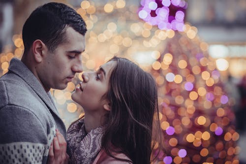 Free Young Couple Kissing in City at Night Stock Photo