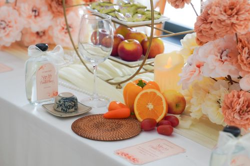 Free A beautifully arranged table with fruits, flowers, and elegant dinnerware for a perfect celebration. Stock Photo