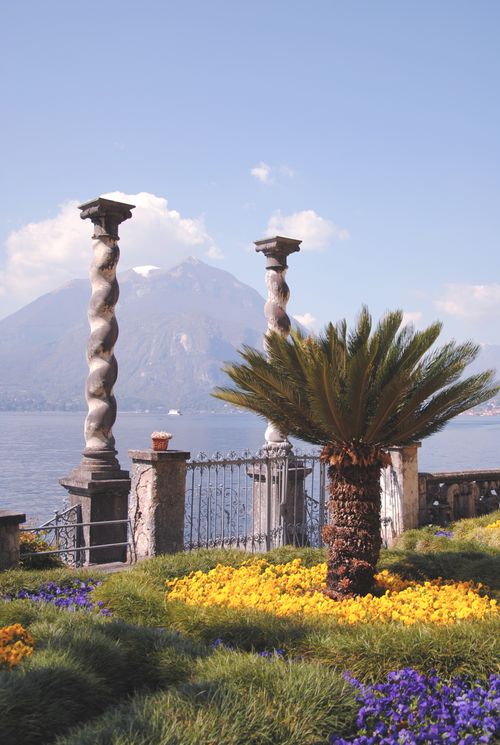 Free A vibrant garden view overlooking Lake Como in Varenna, Lombardia, Italy. Stock Photo