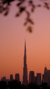 Stunning view of Dubai skyline featuring Burj Khalifa during a vibrant sunset.