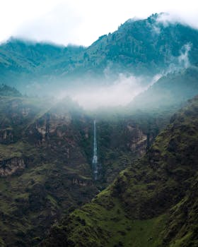 A stunning view of a waterfall amidst mountains in Spiti Valley, Himachal Pradesh.