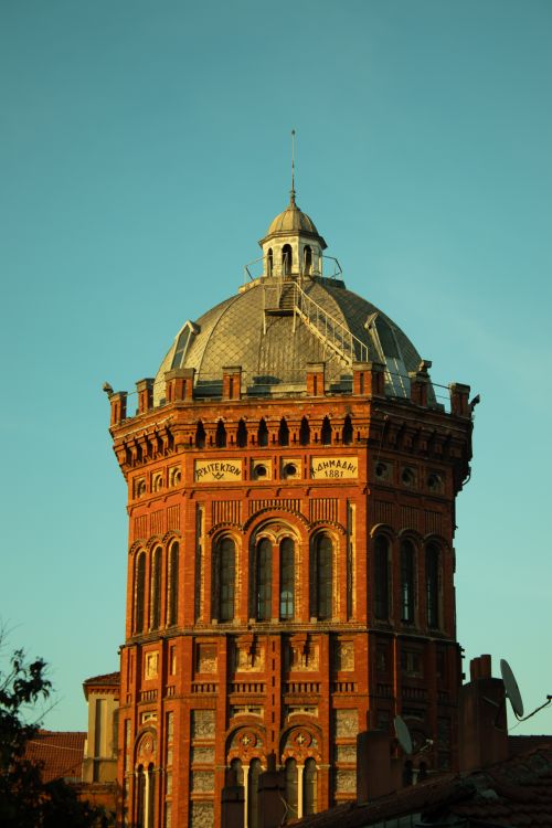 Free Iconic Byzantine-style tower with detailed red brick facade under clear sky. Stock Photo