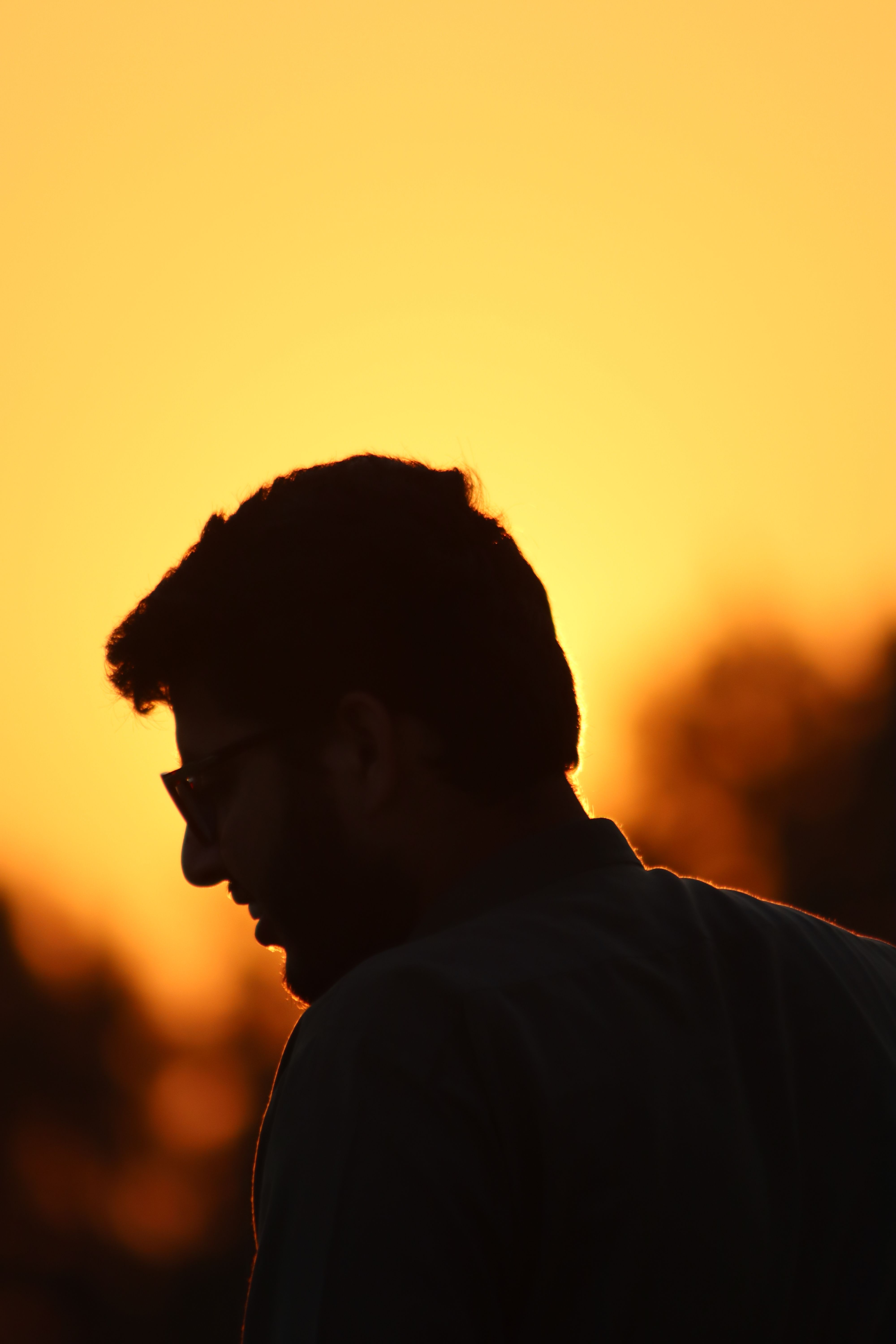 Silhouette of a Man Against Vibrant Sunset · Free Stock Photo