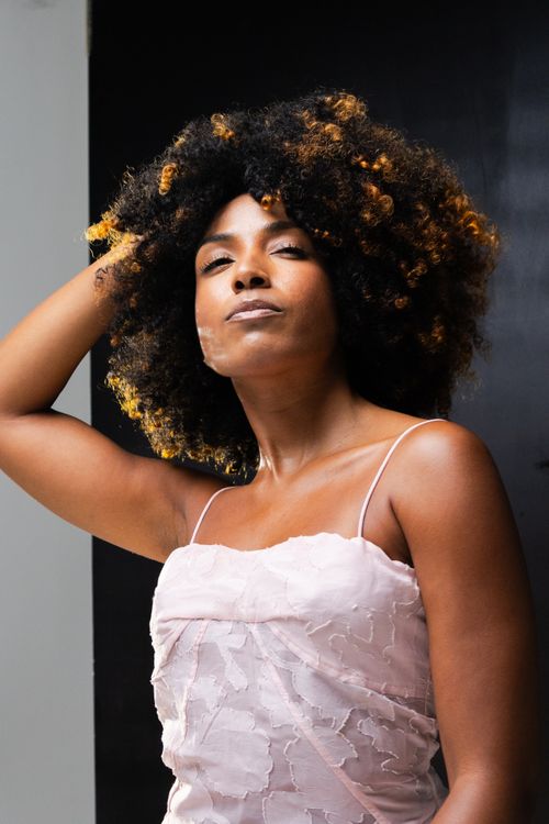 Free Striking portrait of a confident woman in a stylish pink dress, captured in São Paulo. Stock Photo