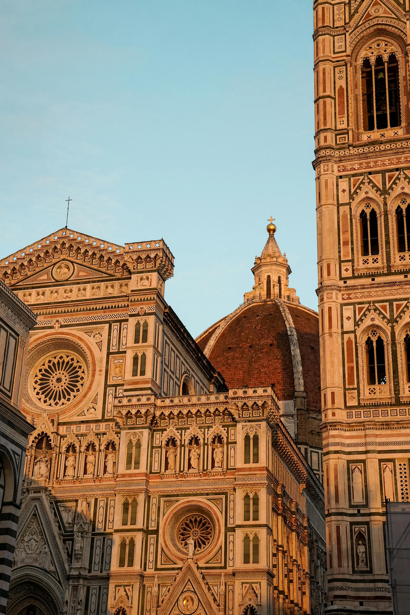 Beautiful view of the Florence Cathedral, showcasing its intricate architecture during a golden sunset in Florence, Italy.