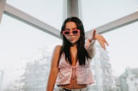 Stylish Young Woman in Sunglasses Indoors