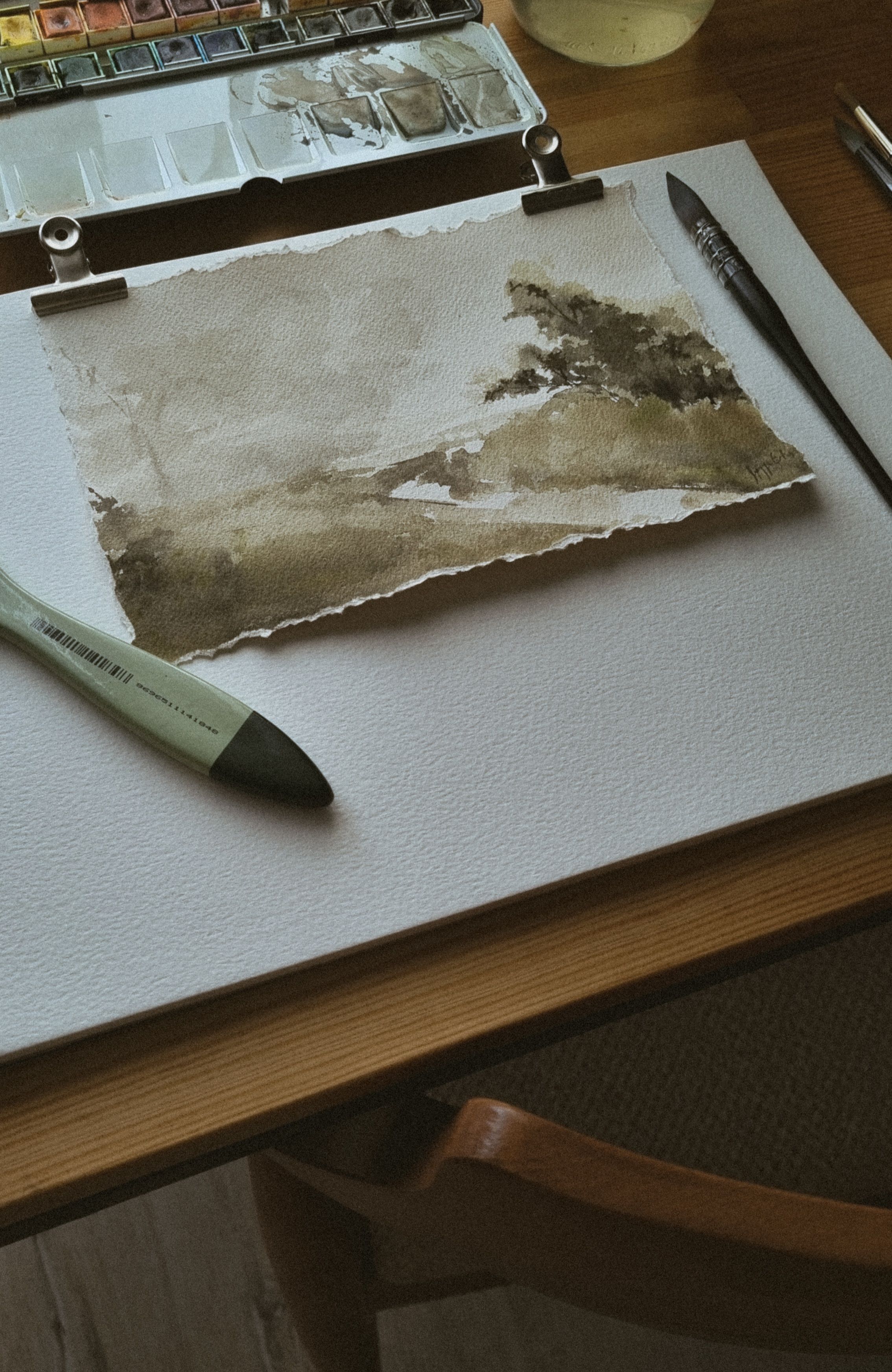 Watercolor landscape painting in a quiet studio