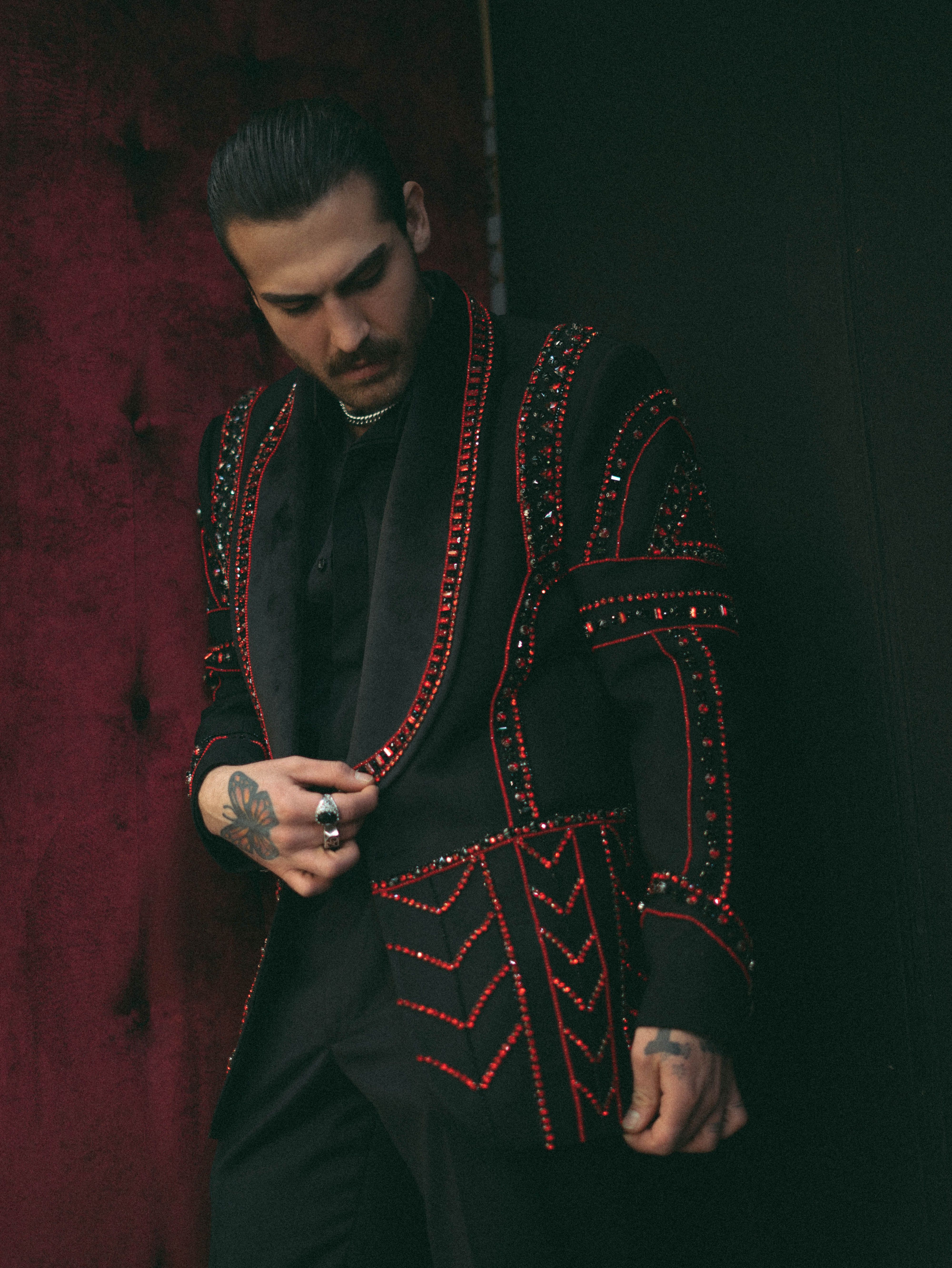 Stylish Man in Embellished Jacket in Moody Setting
