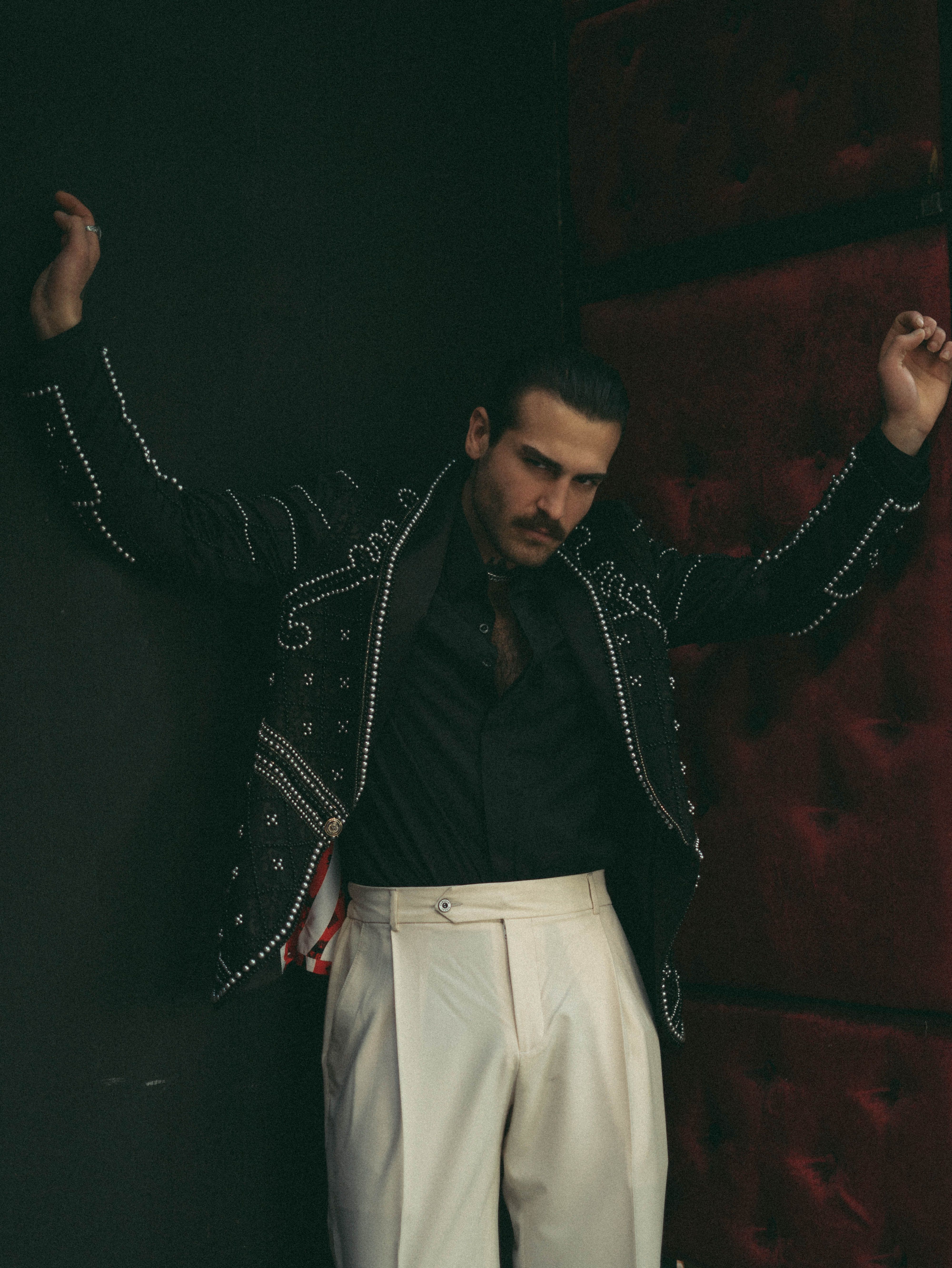 Stylish Man in Embellished Jacket Posing Indoors