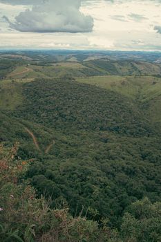 Breathtaking aerial view of lush green hills under a dramatic sky, perfect for nature lovers.