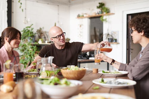 Man Pouring Drink on Woman's Glass