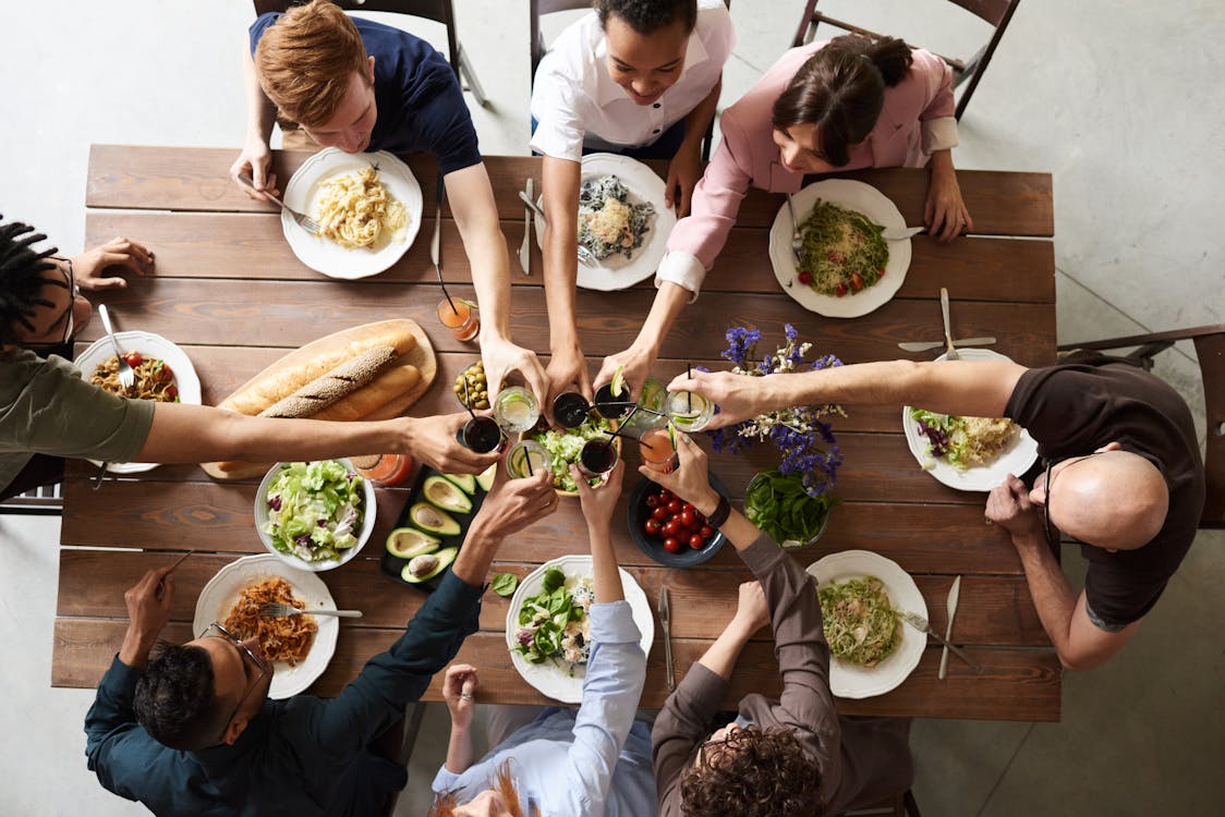 Family members making toast at dinner