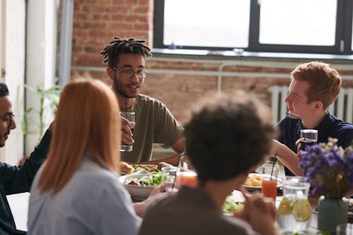 Free Group of Person Eating Indoors Stock Photo