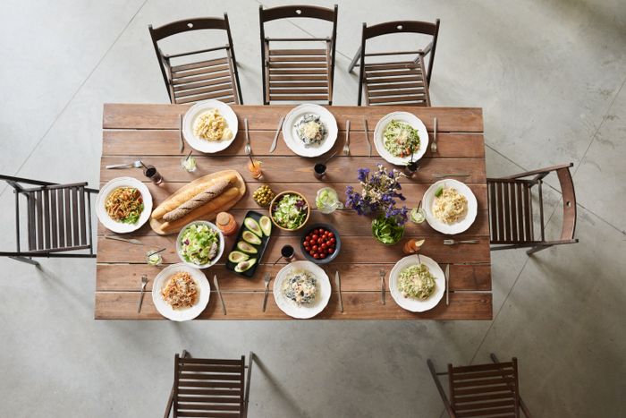 A table set from above with shared pasta dishes
