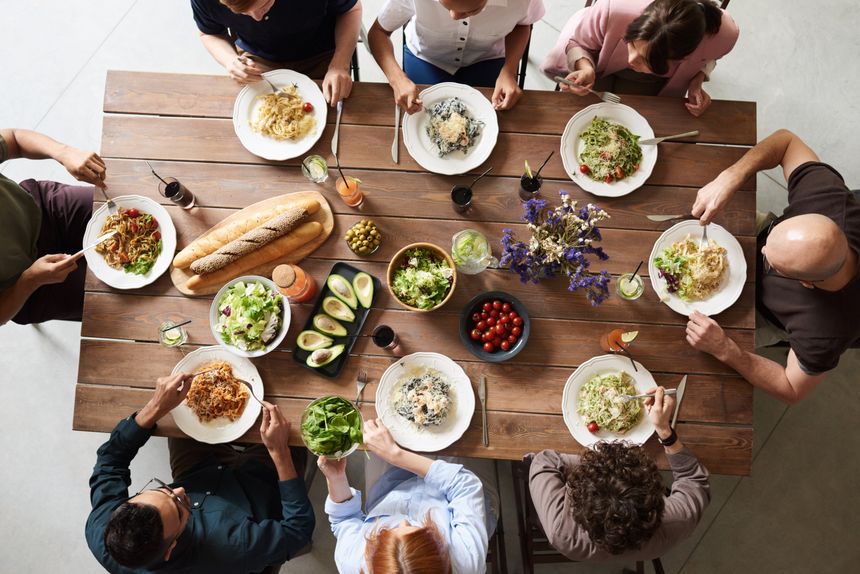 Friends sharing a meal around a table, seen from above — photo by fauxels on Pexels