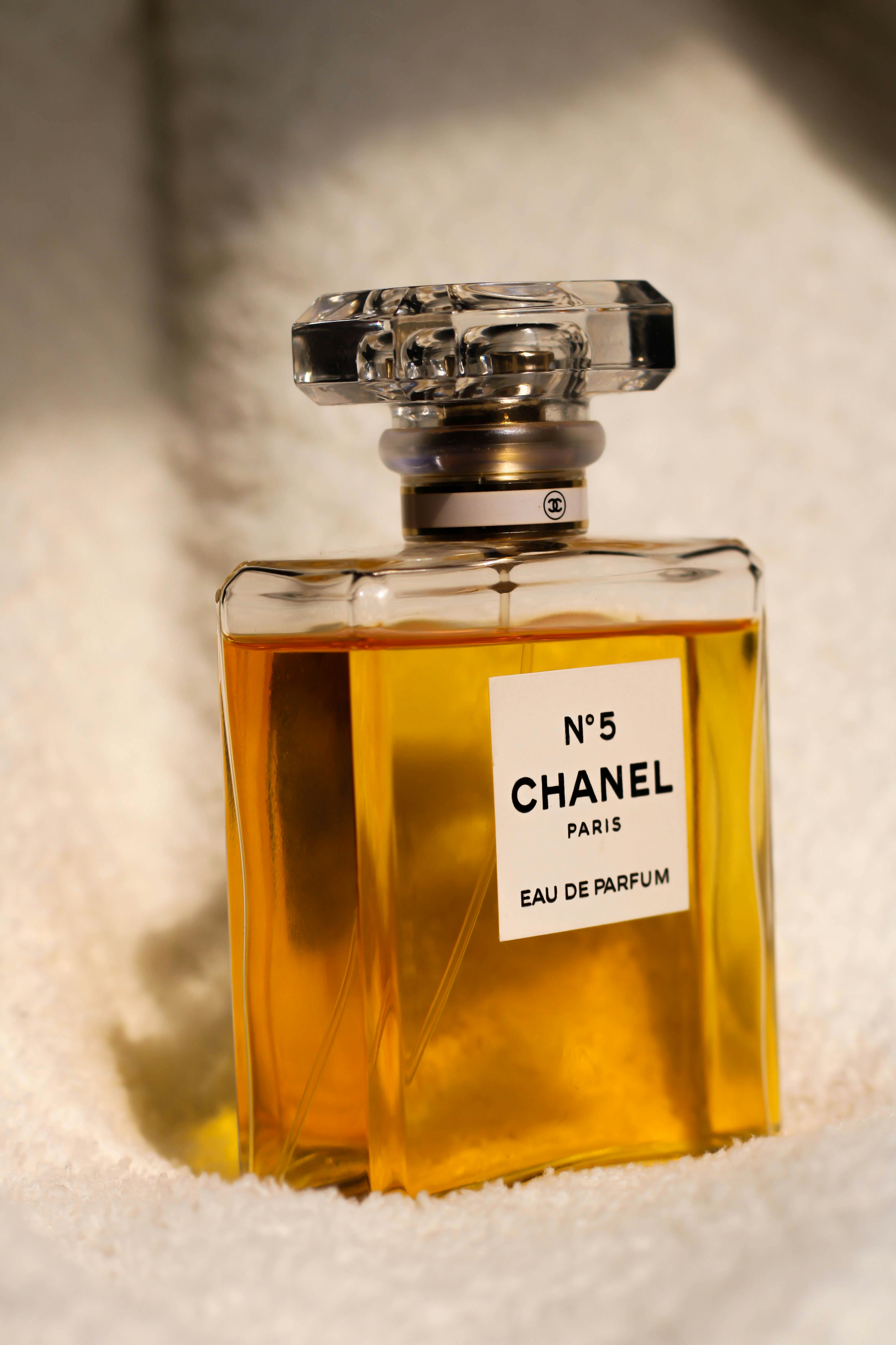 Chanel No.5 Eau de Parfum bottle elegantly placed on a soft fabric surface.