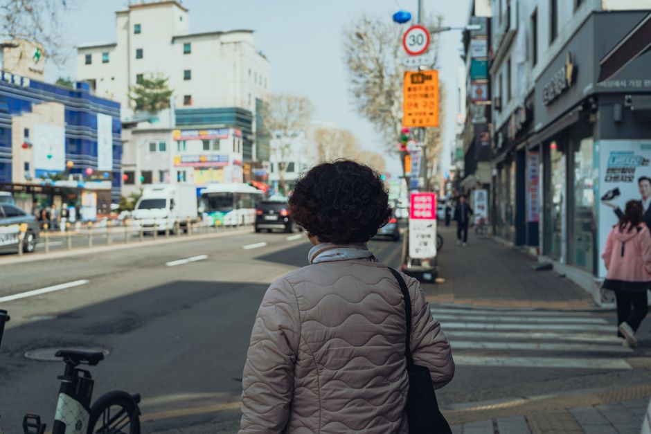 Explore Seoul's vibrant streets with a backdrop of urban architecture and daily life.