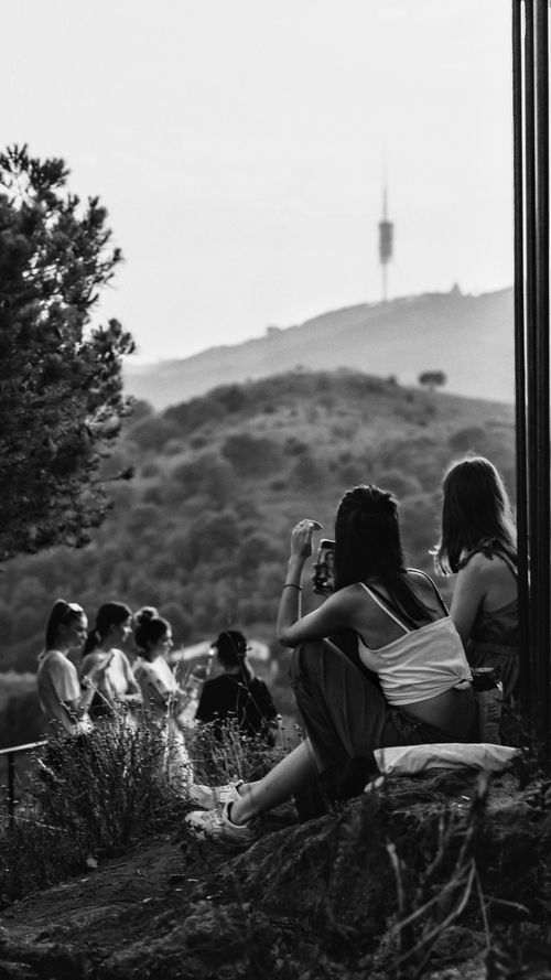 Free A group enjoys the serene hillside view of Barcelona in black and white. Stock Photo