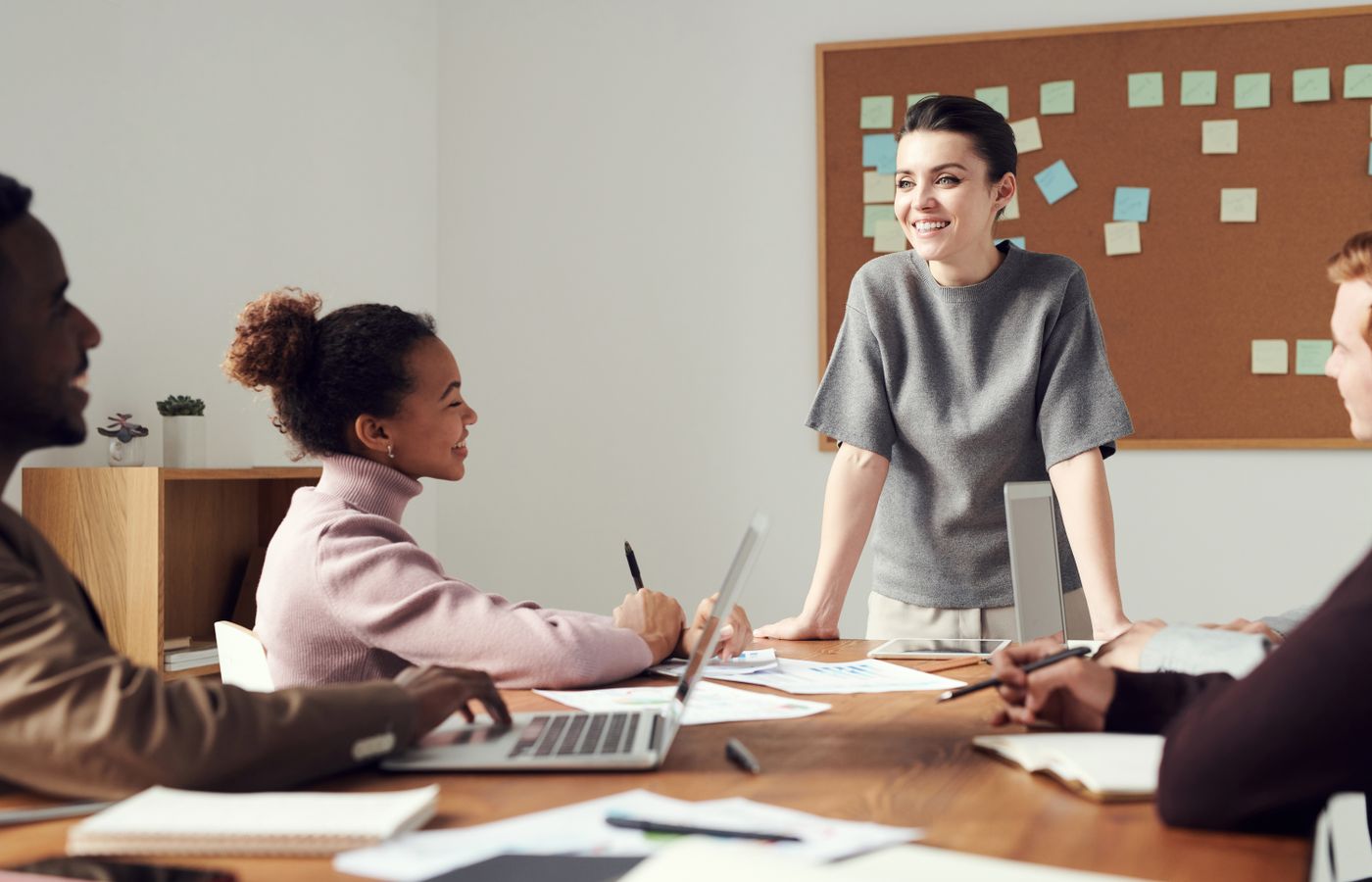Business team collaborating in a modern office setting with diverse colleagues.
