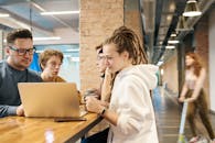 一群成年人在时尚的办公环境中使用笔记本电脑合作开展项目