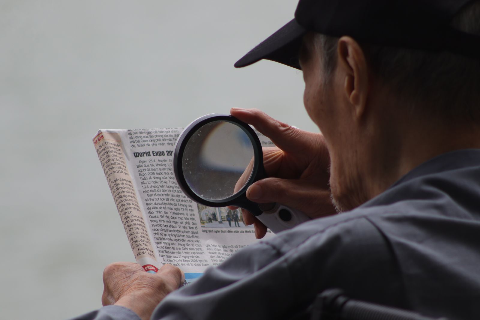 Senior man reading with a magnifying glass