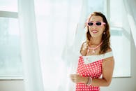 Stylish Woman in Retro Pink Polka Dot Dress Indoors