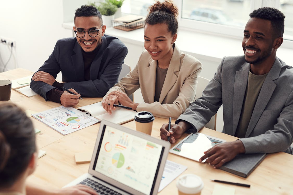 Free Photo of Three People Smiling While Having a Meeting Stock Photo