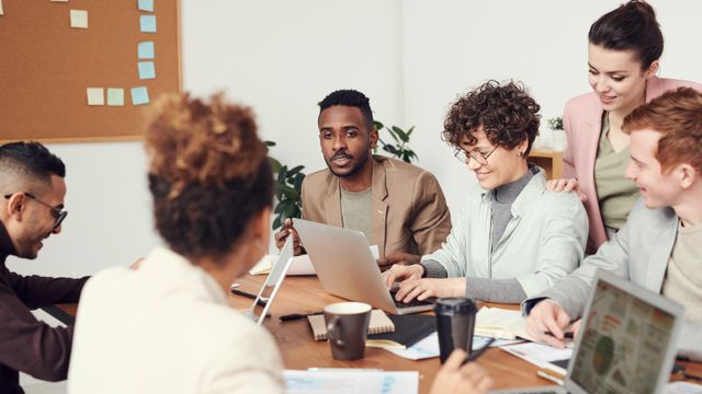Psychologist reviewing her LinkedIn professional profile at a desk