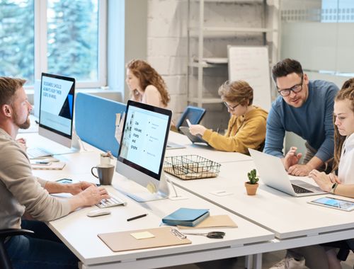 Equipe de TI trabalhando em computadores no escritório