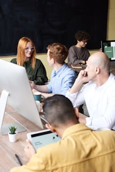 Group of diverse professionals brainstorming in a contemporary office setting.