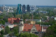 Cityscape of Wroclaw featuring the iconic bridge and historic architecture under a clear sky.