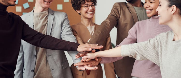 Photo Of People Holding Each Other's Hands