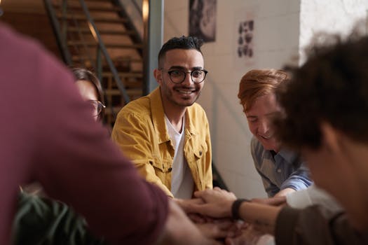 A group of joyful professionals collaborating in a stylish, modern office setting, emphasizing teamwork and connection.
