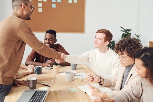 A diverse team in a modern office working together on a project, showcasing teamwork and collaboration.