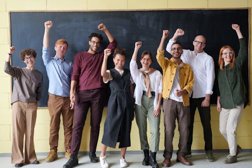 Free Group of People Standing infront of Blackboard Stock Photo