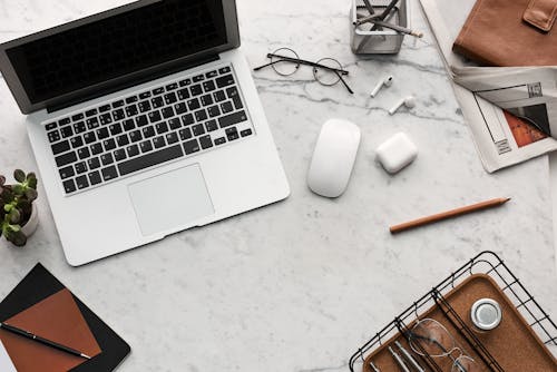 Flatlay Display of Electronics next to Eyeglases