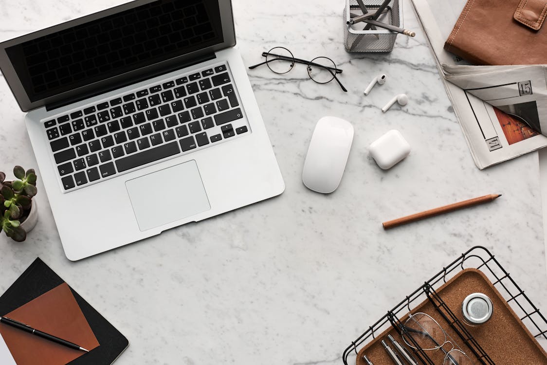 Flatlay Display of Electronics next to Eyeglases