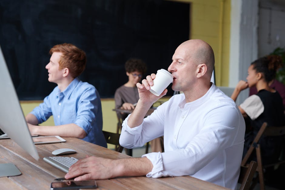 Casual office scene with diverse team collaborating and working on projects.