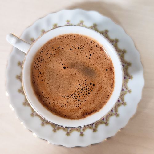 Free Top view of a frothy cup of Turkish coffee in a decorative porcelain cup. Stock Photo