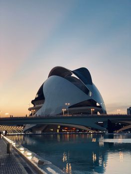 Stunning view of Ciudad de las Artes y las Ciencias in Valencia at dusk reflecting in water.