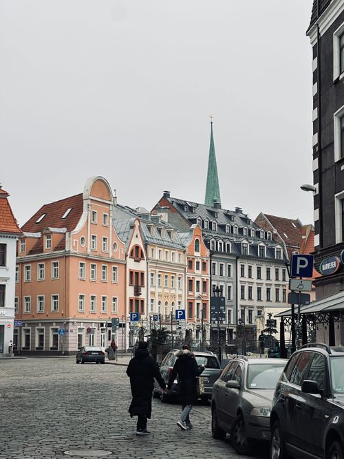 Free Charming street scene in Riga with colorful buildings and pedestrians on a cloudy day. Stock Photo