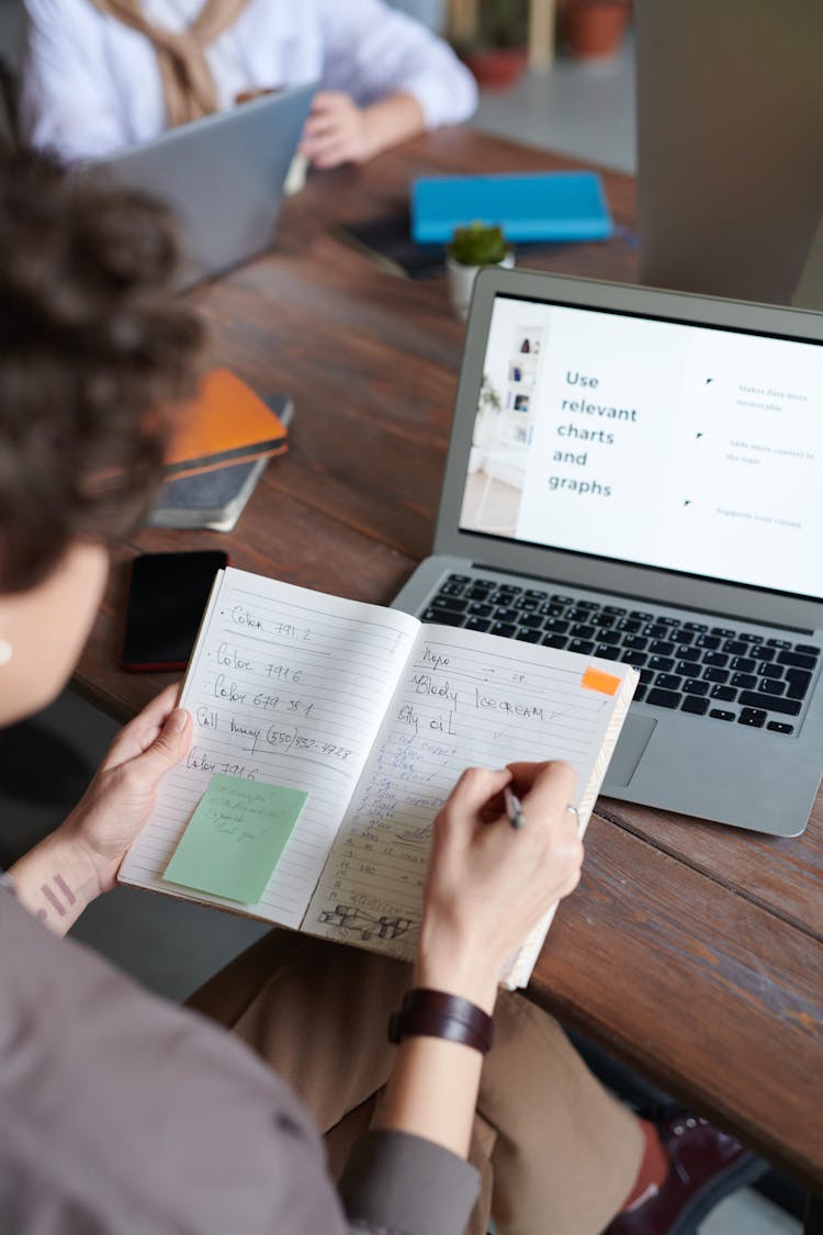 Photo Of Person Writing On Notebook