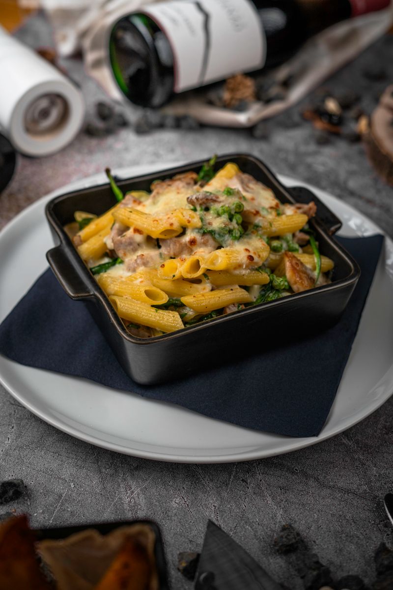 Tantalizing baked pasta dish with melted cheese and vegetables, perfect for food lovers.