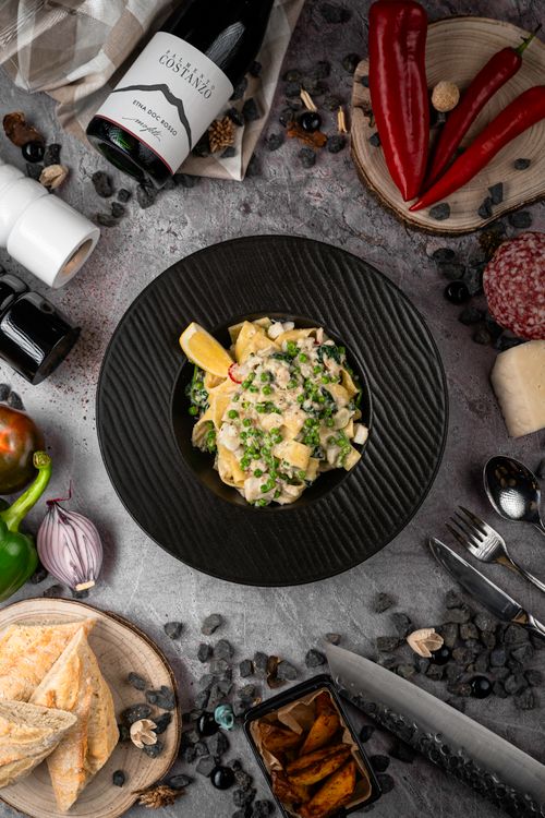 Free Flat lay of creamy pasta with herbs and ingredients, perfect for culinary inspiration. Stock Photo