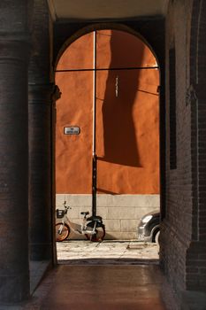 Capture the essence of Bologna with its iconic portici, archways, and bicycles in motion.