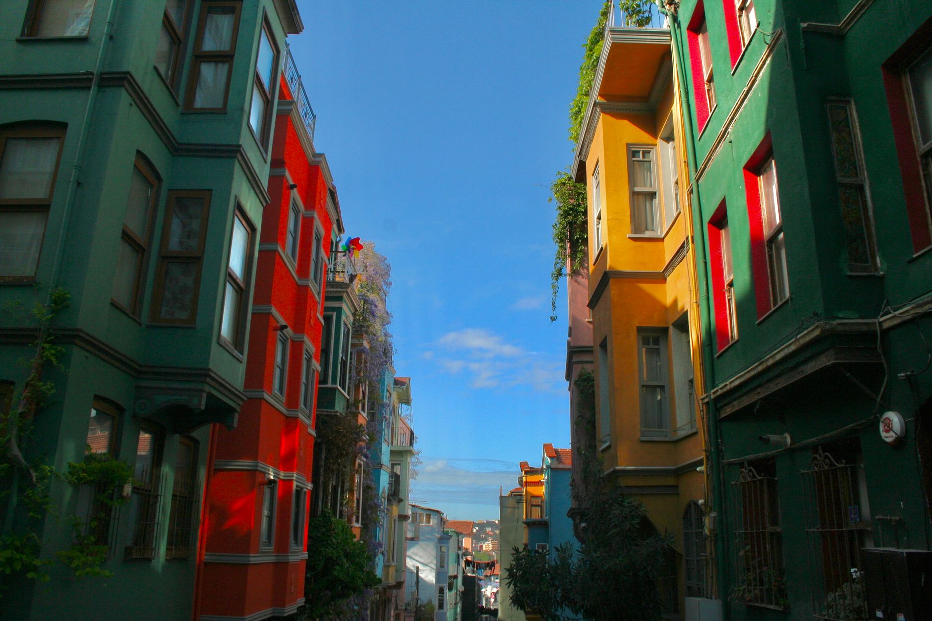 Vibrant street scene with colorful buildings in Istanbul's Balat neighborhood.