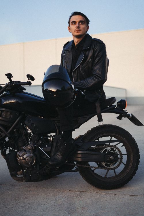 Free Adult man in black leather jacket with motorcycle at dusk. Stock Photo